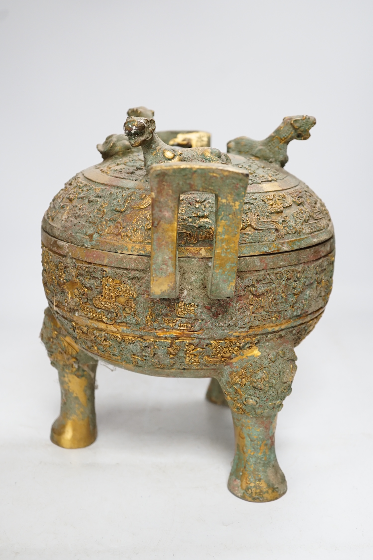 A Chinese archaistic bronze tripod censor and cover with tiger finials, height 18cm. Condition - fair for age